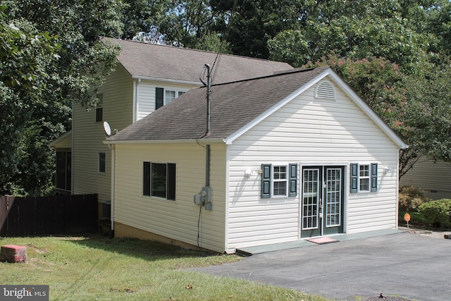 rear view of house with a yard