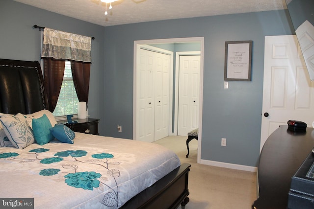 carpeted bedroom featuring a textured ceiling and a closet