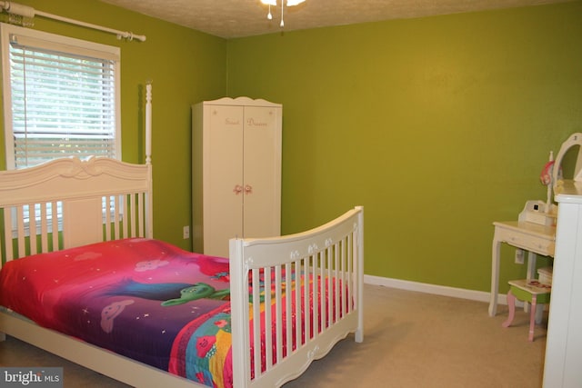 carpeted bedroom with a textured ceiling