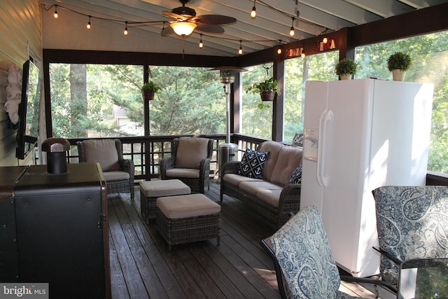 wooden deck with ceiling fan and outdoor lounge area