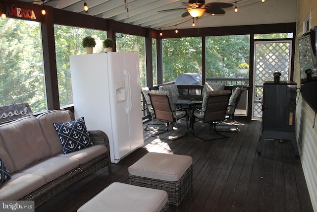 sunroom featuring lofted ceiling and ceiling fan