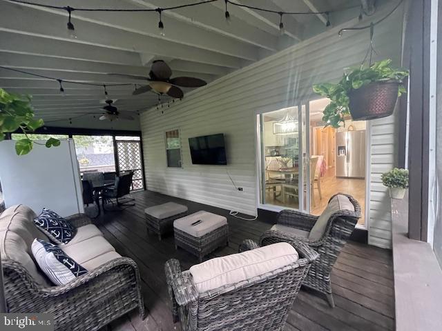 deck featuring ceiling fan and outdoor lounge area