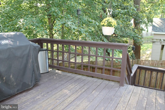 wooden deck with a grill