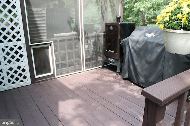 wooden terrace with a grill