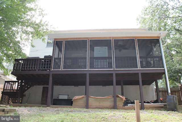 back of property with a sunroom