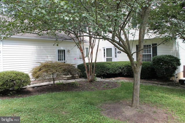 view of home's exterior with a yard