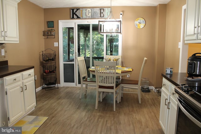 dining room with an inviting chandelier and light wood-type flooring