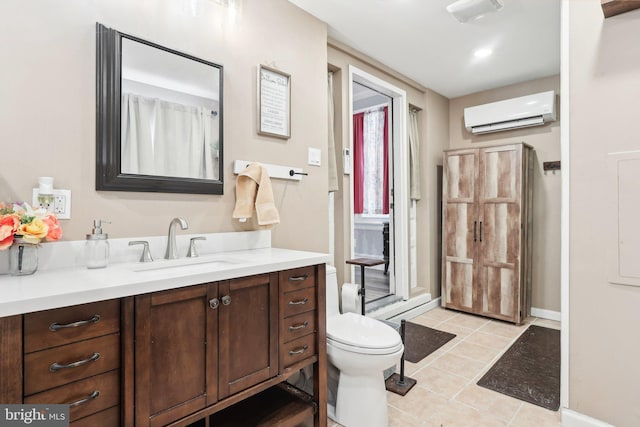 bathroom with toilet, a wall mounted AC, vanity, and tile patterned floors