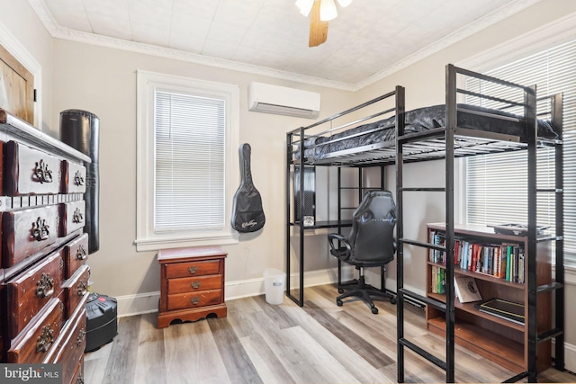 bedroom with baseboards, a wall mounted air conditioner, wood finished floors, and crown molding