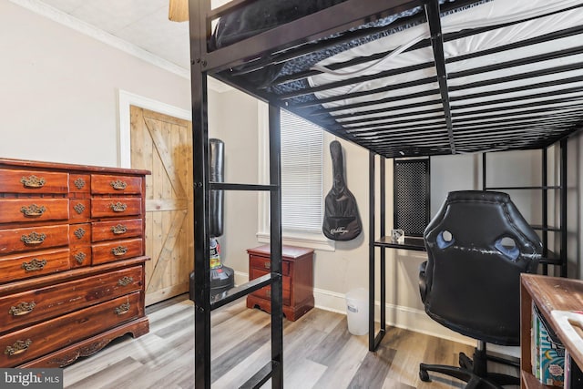 bedroom featuring light wood-style flooring and baseboards