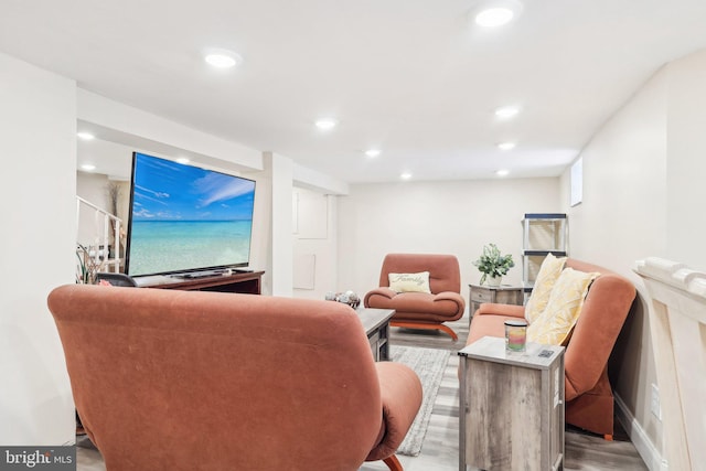 living area featuring wood finished floors and recessed lighting