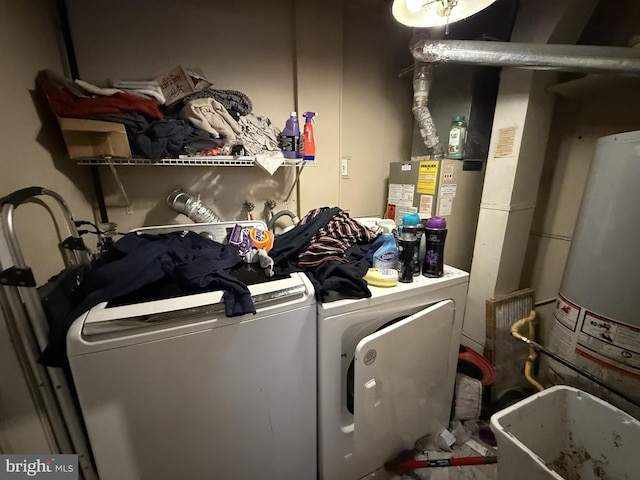 laundry area with water heater and washer and dryer