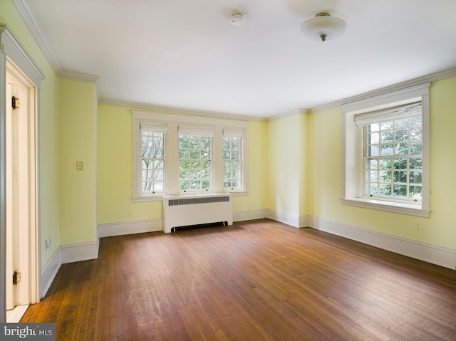 spare room featuring radiator, hardwood / wood-style flooring, and ornamental molding