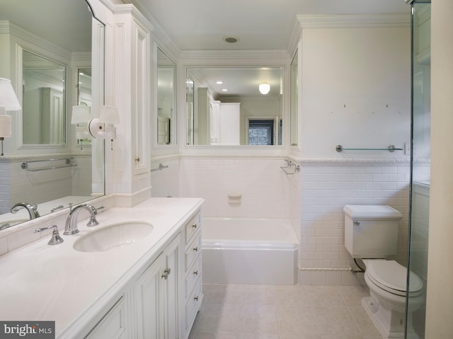 bathroom featuring a bathing tub, tile walls, vanity, toilet, and tile patterned floors