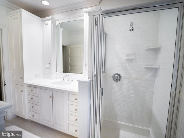 bathroom with ornamental molding, a shower with shower door, tile patterned flooring, and vanity