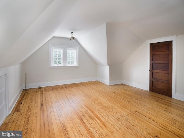 bonus room featuring vaulted ceiling and light wood-type flooring