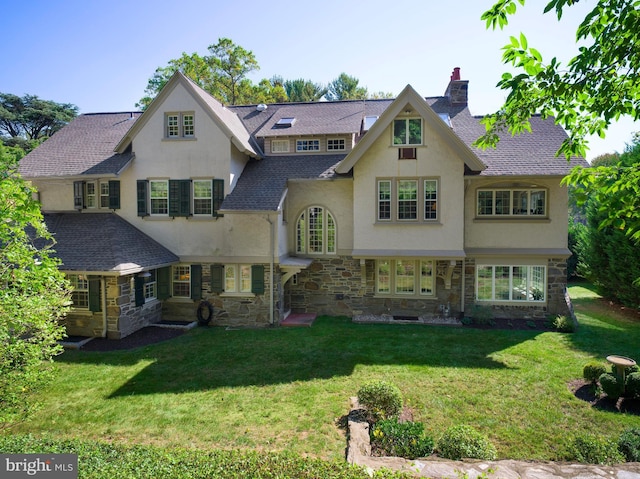 rear view of house featuring a yard