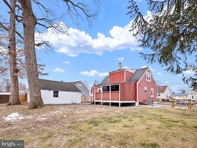 back of property featuring a lawn