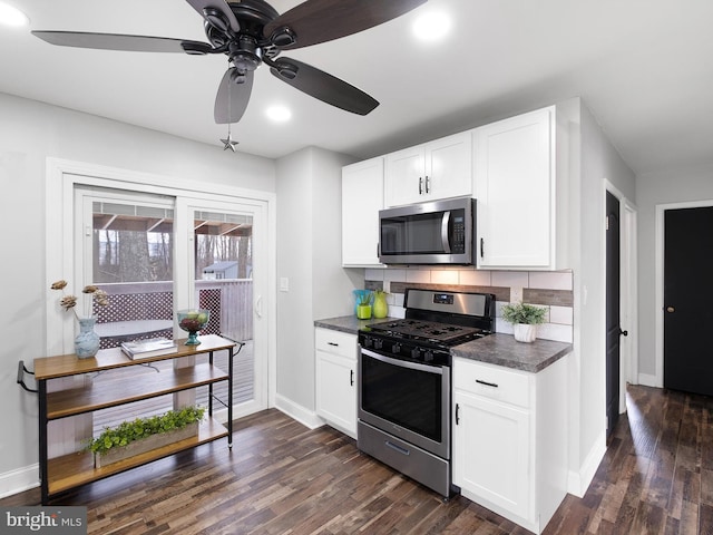 kitchen featuring ceiling fan, dark hardwood / wood-style floors, decorative backsplash, white cabinetry, and stainless steel appliances