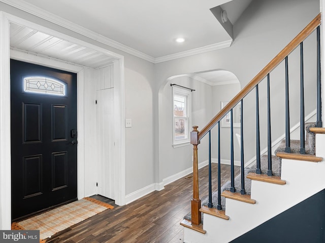 foyer entrance with dark hardwood / wood-style flooring and crown molding