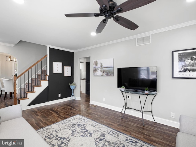 living room with ceiling fan, dark hardwood / wood-style floors, and ornamental molding