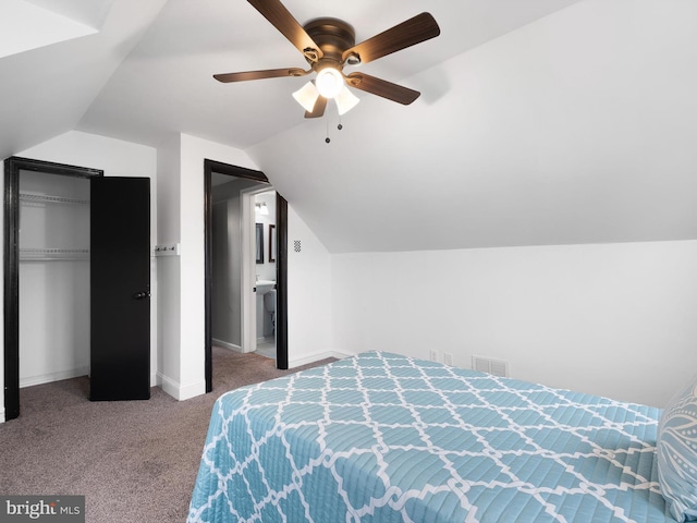 carpeted bedroom with ceiling fan, a closet, and vaulted ceiling