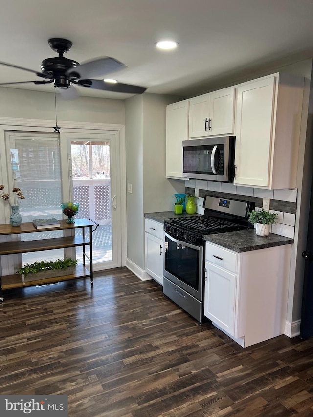 kitchen with ceiling fan, appliances with stainless steel finishes, white cabinetry, and dark hardwood / wood-style floors