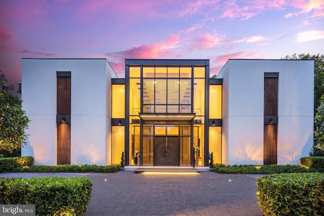 view of outdoor building at dusk