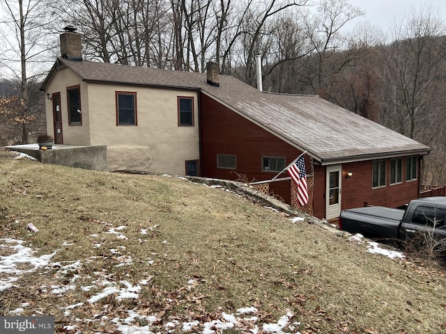 view of snowy exterior featuring a yard