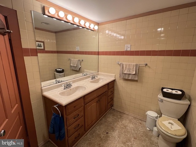 bathroom featuring tile walls, vanity, and toilet