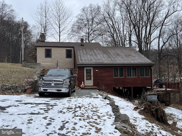 view of snow covered back of property