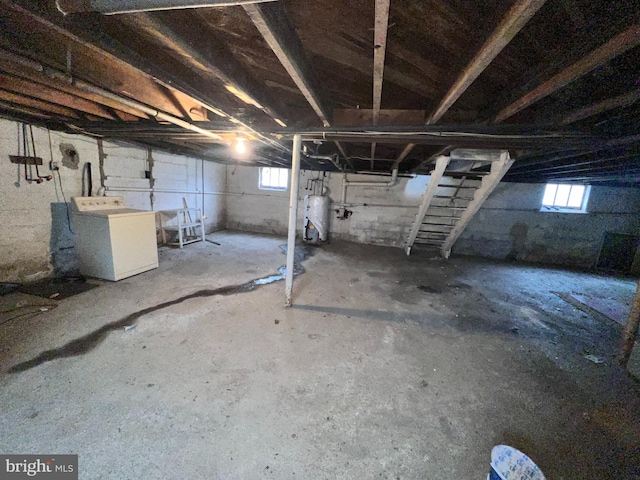 basement featuring washer / clothes dryer and water heater