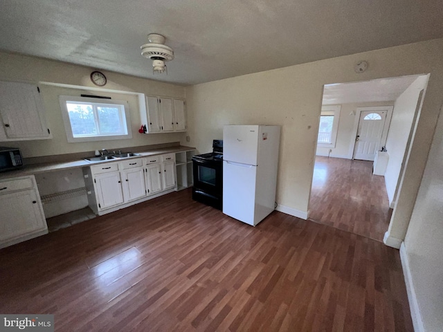 kitchen with black appliances, dark hardwood / wood-style floors, white cabinets, and sink