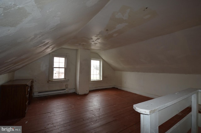 bonus room with a baseboard heating unit, vaulted ceiling, and dark hardwood / wood-style flooring