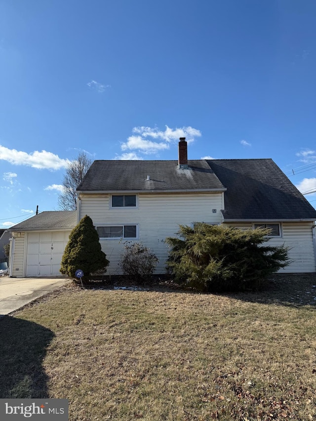 view of property exterior featuring a garage and a lawn