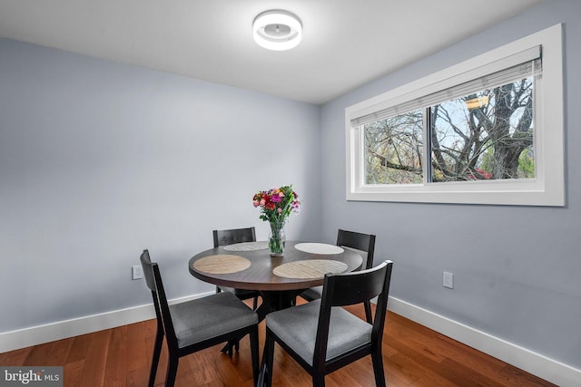 dining space featuring wood-type flooring