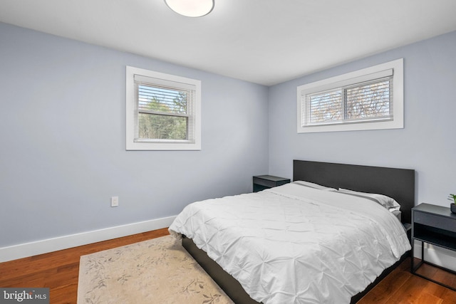 bedroom featuring hardwood / wood-style floors and multiple windows