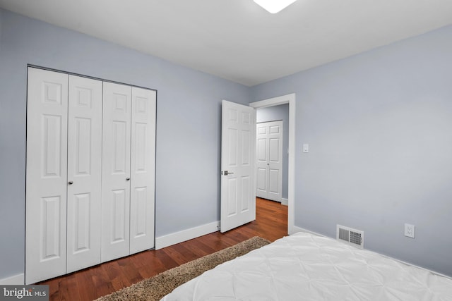 bedroom with a closet and hardwood / wood-style floors