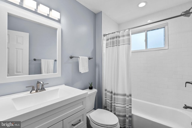 full bathroom featuring toilet, shower / bathtub combination with curtain, and vanity