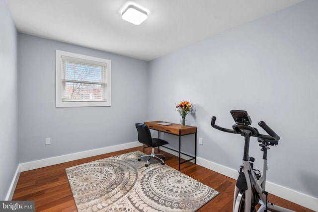 home office with dark wood-type flooring