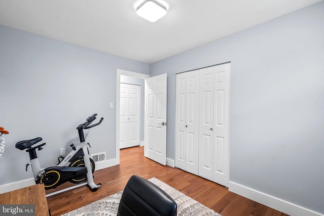 workout area featuring light hardwood / wood-style floors