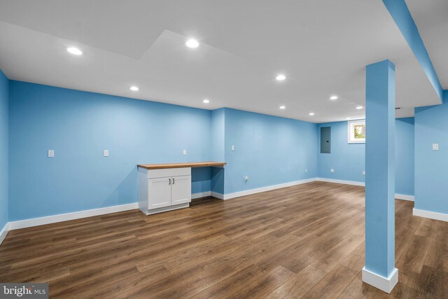 basement with hardwood / wood-style flooring and built in desk