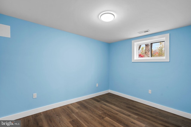 unfurnished room with hardwood / wood-style flooring