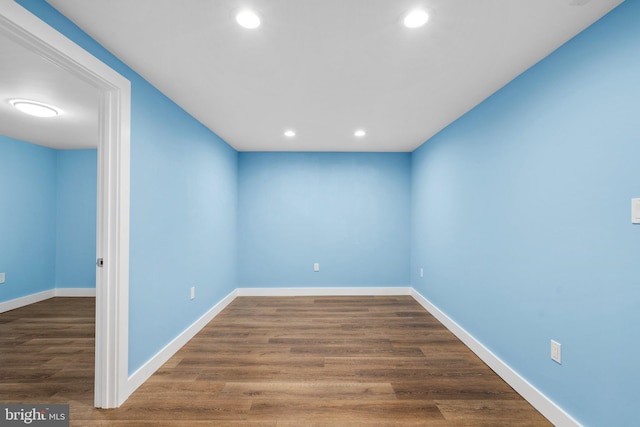 unfurnished room featuring dark hardwood / wood-style flooring