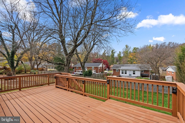 wooden terrace with a yard and an outdoor structure