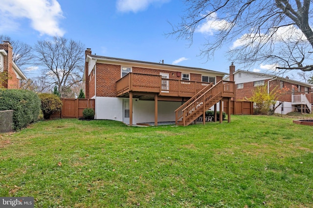 rear view of property with a yard and a deck