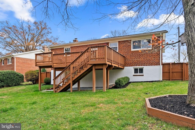 back of property with a yard and a wooden deck