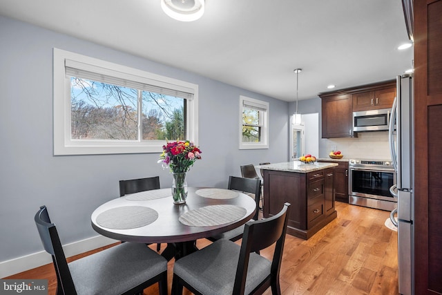 dining area featuring light wood-type flooring