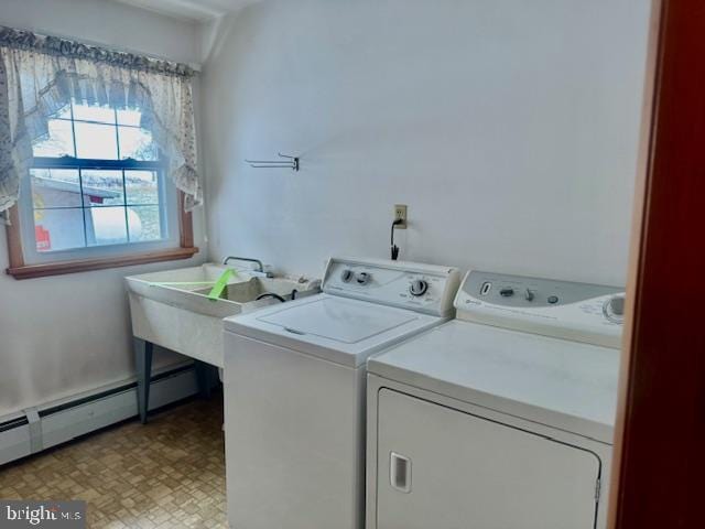 laundry room with washing machine and clothes dryer and baseboard heating