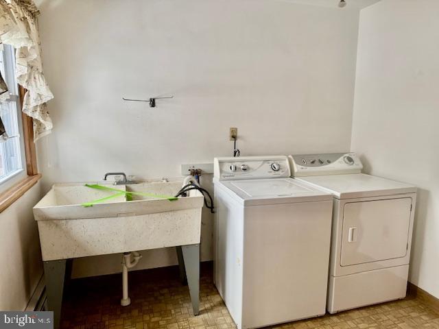 clothes washing area with separate washer and dryer